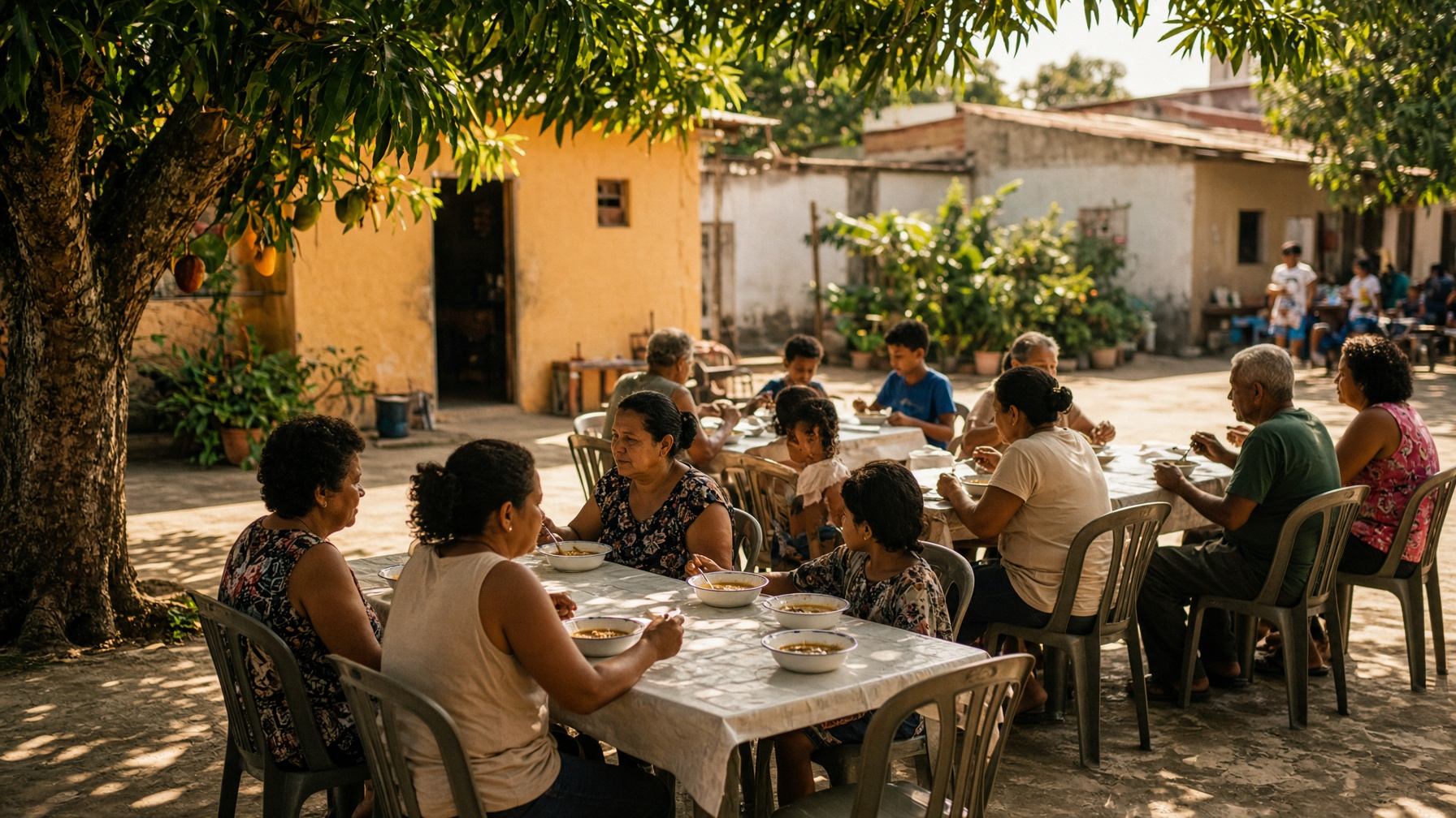 Famílias reunidas em um pátio comendo sopa juntas